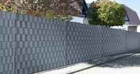 Polypropylene wind and privacy screen strips in anthracite, 26 meters long by Zaunpaket24, rolled and ready for installation.